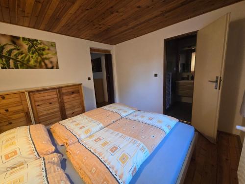 a bedroom with a bed and a wooden ceiling at Apartmány Lebedín in Nová Ves