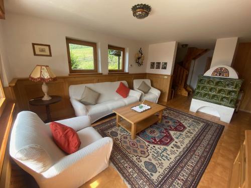 a living room with a couch and a coffee table at Chalet Genziana in Cavalese