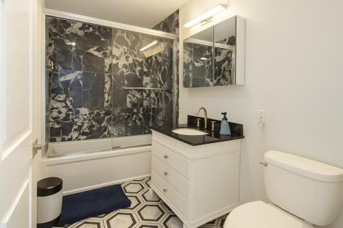 a bathroom with a toilet and a sink at Adam's apartment Modern 3BR 2BA Free Parking by Swampscott Beach By Amana Green realty in Swampscott