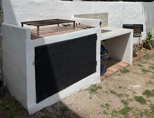 a door to a building with a bench on top at Tres Soles in Salsipuedes