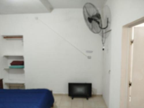 a living room with a blue couch and a tv at Tote Esquina in Esquina