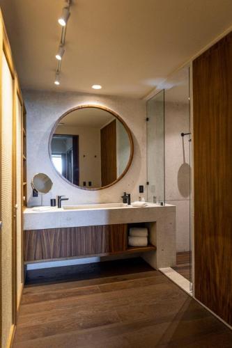 a bathroom with a large mirror and a sink at Los Veneros Punta de Mita - Pacific Tower in Punta Mita