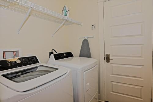 a white laundry room with a washer and dryer at Prominence 30A - Mint Julep in Inlet Beach