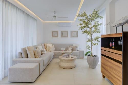 a living room with a couch and a table at Vista Natura, Luxury Home Near the Beach in Nuevo Vallarta