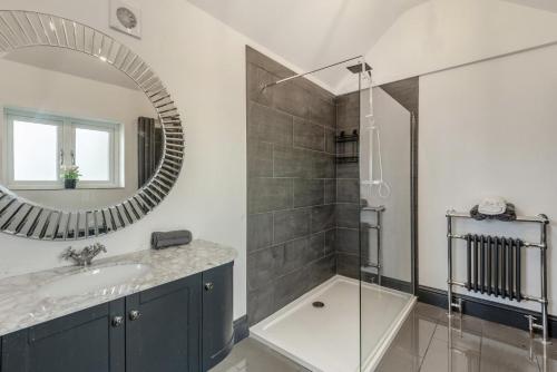 a bathroom with a sink and a mirror at 3 Bed in Mealsgate oc-e33626 in Mealsgate