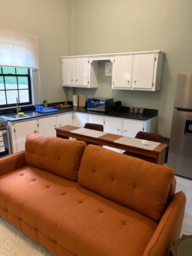 a living room with a couch in a kitchen at Carolus Suites in Gros Islet