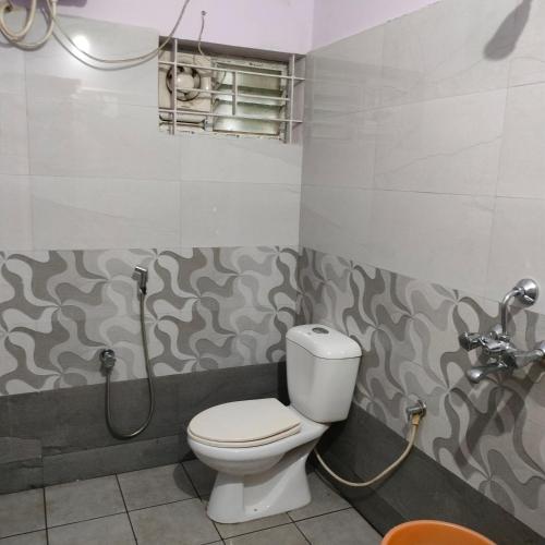 a bathroom with a toilet and a shower at Wild Nest Kotagiri in Kotagiri