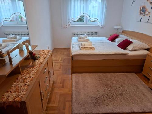 a bedroom with two beds and a large mirror at Apartment Meli Varazdin in Varaždin