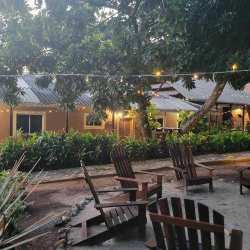 a group of chairs sitting in front of a building at Promisedland Tayrona Cabins Hotel in Buritaca