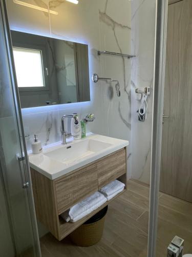 a bathroom with a sink and a mirror at BEACH WHTE VILLAs one bedroom in Minia