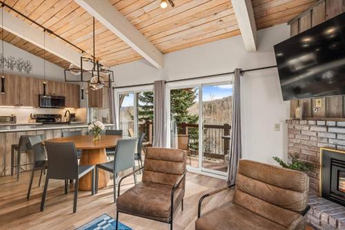 a kitchen and dining room with a table and chairs at Woodbridge 29E in Snowmass Village