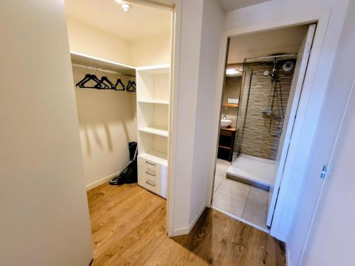 a bathroom with a walk in shower and a mirror at Appartement moderne 3 pièces aux Arcs 1800 - FR-1-346-537 in Arc 1800