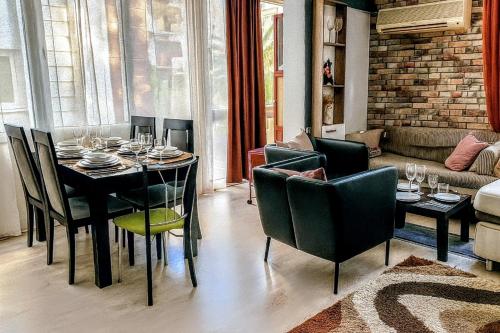 a dining room with a table and chairs and a couch at Luxury and Comfort in Central Alsancak Perfect for Groups or Families in Izmir