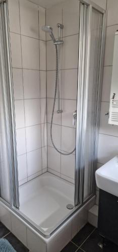 a shower with a glass door in a bathroom at Sonne in Lünen