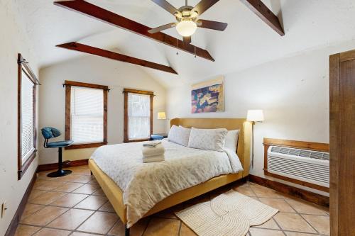 a bedroom with a bed and a ceiling fan at Main Street Wood Cottage in Brevard