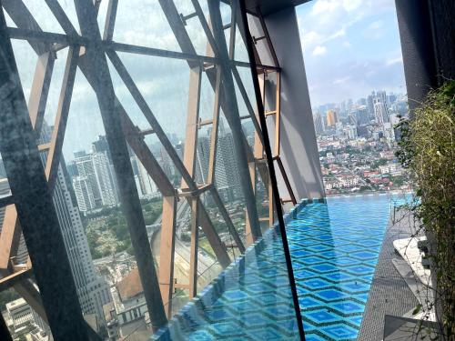 a swimming pool on the top of a skyscraper at Scarletz suites klcc Twin Tower by ESD in Kuala Lumpur