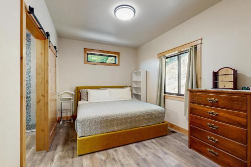 a bedroom with a bed and a dresser and a window at Rocky Crest Retreat in Somers