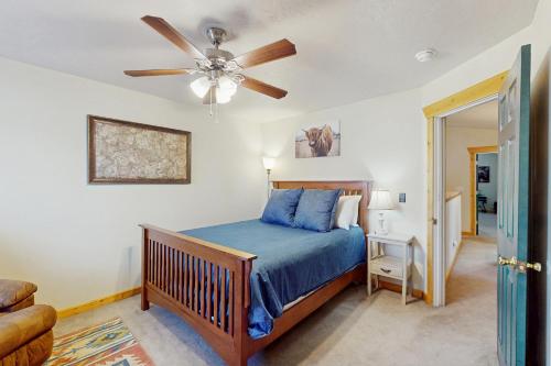 a bedroom with a bed and a ceiling fan at Saddle Peak Outpost- Unit A & B in Belgrade
