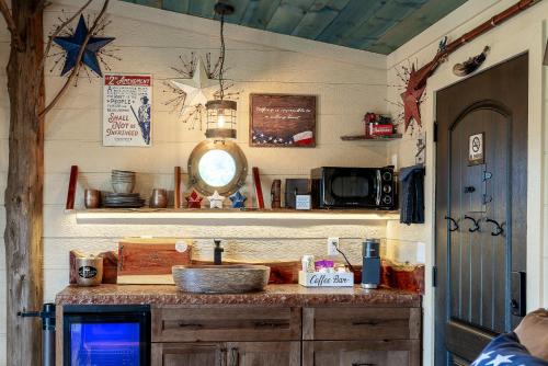 a kitchen with a counter with a sink and a shelf at "Land of the Free, Home of the Brave" Double Luxury Treehouse for 12 Near Dollywood & Pigeon Forge in Catlettsburg