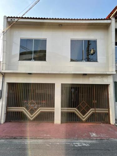 a building with two garage doors and two windows at Residência COP 30 in Ananindeua