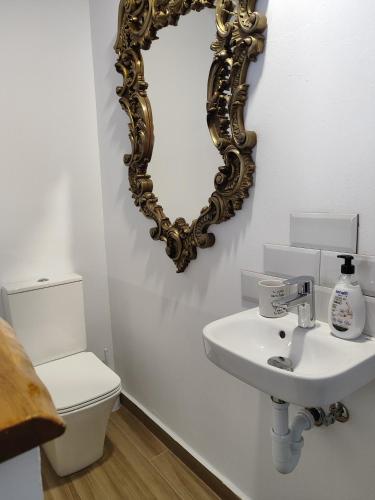 a bathroom with a sink and a mirror on the wall at La casa del patio in Ágreda
