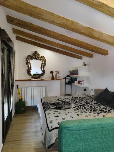 a bedroom with a bed and a mirror at La casa del patio in Ágreda