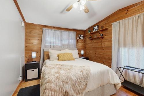 a bedroom with a bed and a ceiling fan at Papa's Cabin in Wilmot