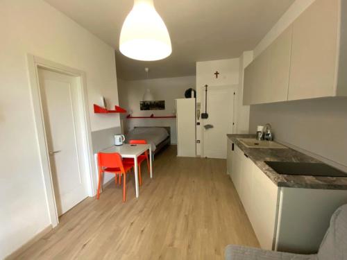 a kitchen with a table and a bed in a room at Studio Lido 10 in Lido delle Nazioni