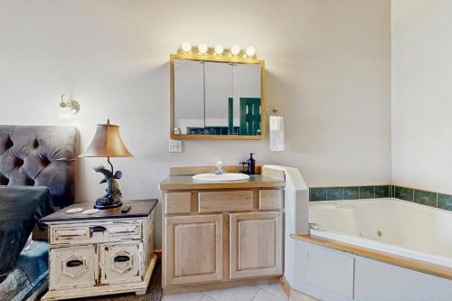 a bathroom with a sink and a bath tub at The Anglers Retreat - Unit A in Belgrade