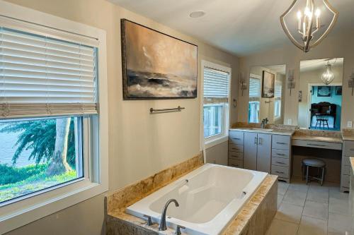 a large bathroom with a tub and a sink at The Sound at Seaglade in Seaglades