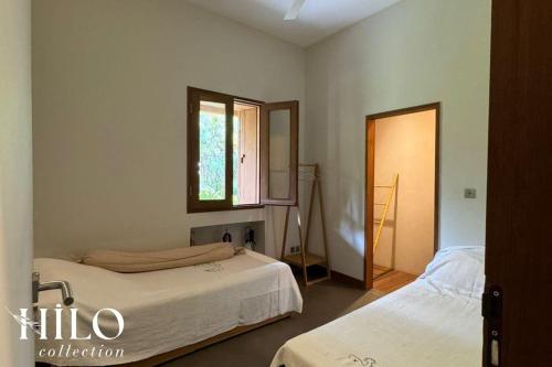 Postel nebo postele na pokoji v ubytování Noddi Beach Villa La Saline by HILO Collection