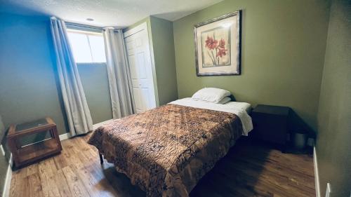 a bedroom with a bed in a room with a window at Private Rooms in a 3 Bedroom Guest House Close to Kingsway NAIT 1 Person per Room No Couples For Men Only in Edmonton