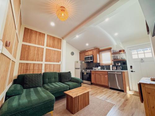 a living room with a green couch and a kitchen at Stylish 2 BR 1 BA Apartment - Steps to the Ocean - Hidden Gem in Wildwood