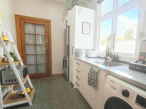 a kitchen with a sink and a stove at Guest Wing on Glasgow in Feilding