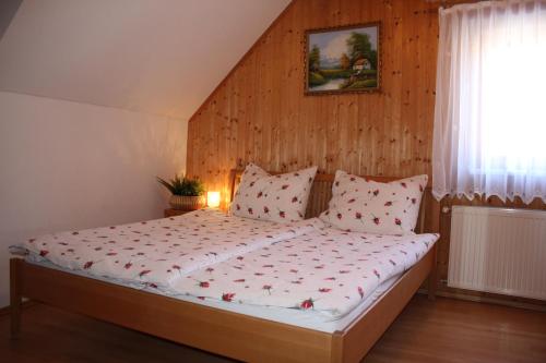 a bedroom with a bed with a wooden wall at Ferienhaus Riegler in Sankt Georgen bei Neumarkt