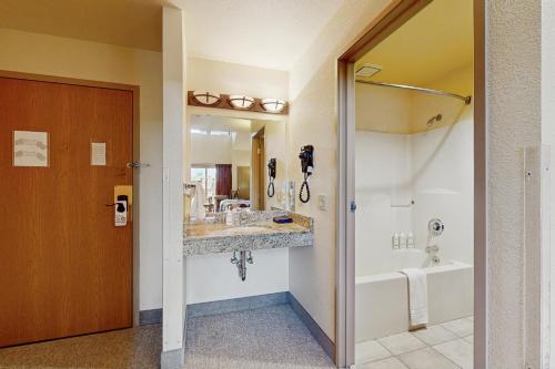 a bathroom with a sink and a tub and a shower at Dells Den Condo #7306 in Wisconsin Dells