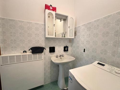 a bathroom with a sink and a mirror at Tra Cielo e Mare da Vale in Fano