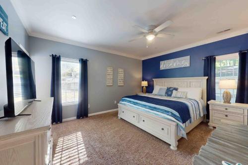 a blue bedroom with a bed and a ceiling fan at 28 White Horse Dr, Ocean Pines, MD 21811 in Ocean Pines