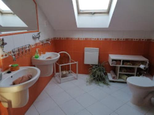 a bathroom with two sinks and a toilet at Penzion Helena a chata Helena in Střílky