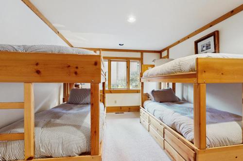 a bedroom with two bunk beds in a house at Bear Creek Pond Chalet in Alpine Meadows