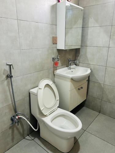 a bathroom with a toilet and a sink at Tiger Wildlife Resort in Bharatpur