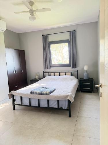 a bedroom with a large bed with a window at Cottage in Urla