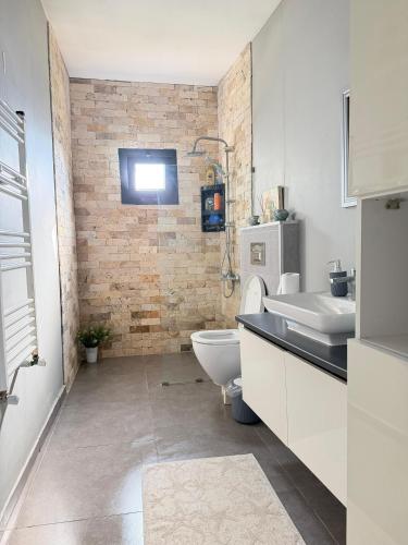 a bathroom with a white toilet and a sink at Cottage in Urla