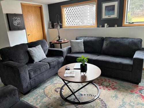 a living room with a couch and a table at Amazing Views, Northern Lights, Stargazing Entire Guest Suite in Golden, BC Canada in Golden