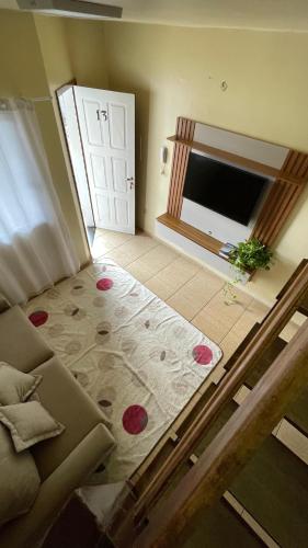 a room with a bed and a door with a floor at Apto 13 - Residencial Canaã in Porto Velho