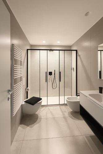 a bathroom with two toilets and a shower at Marisabella Suite Spa 4 in Bari