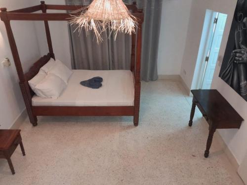 a room with a bed with a hat on it at Elegant Double Big Room at Villa Paradise in Diani Beach