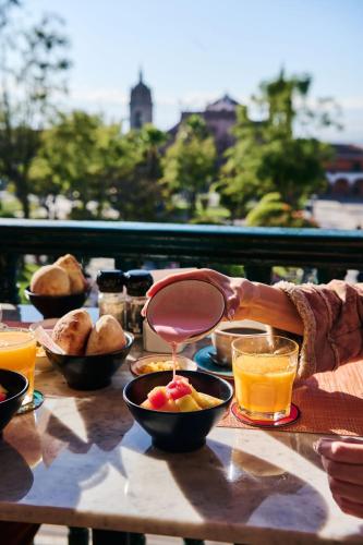 a person is serving food on a table at Casa Andina Standard Ayacucho in Ayacucho
