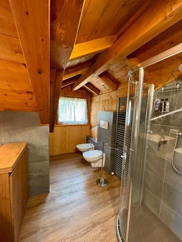 a bathroom with two toilets and a shower at Sky Lodge Bellamonte in Bellamonte