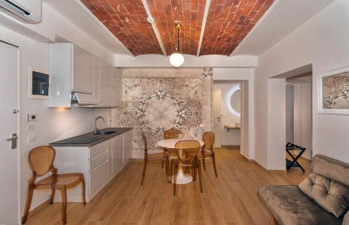 a kitchen and living room with a table and chairs at Tirreno Beachfront Apartments in Marina di Massa